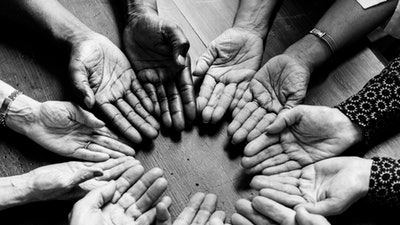 ten human hands grouped in a circle