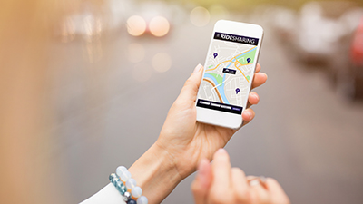 hand holding a smart phone with a map app visible on the screen